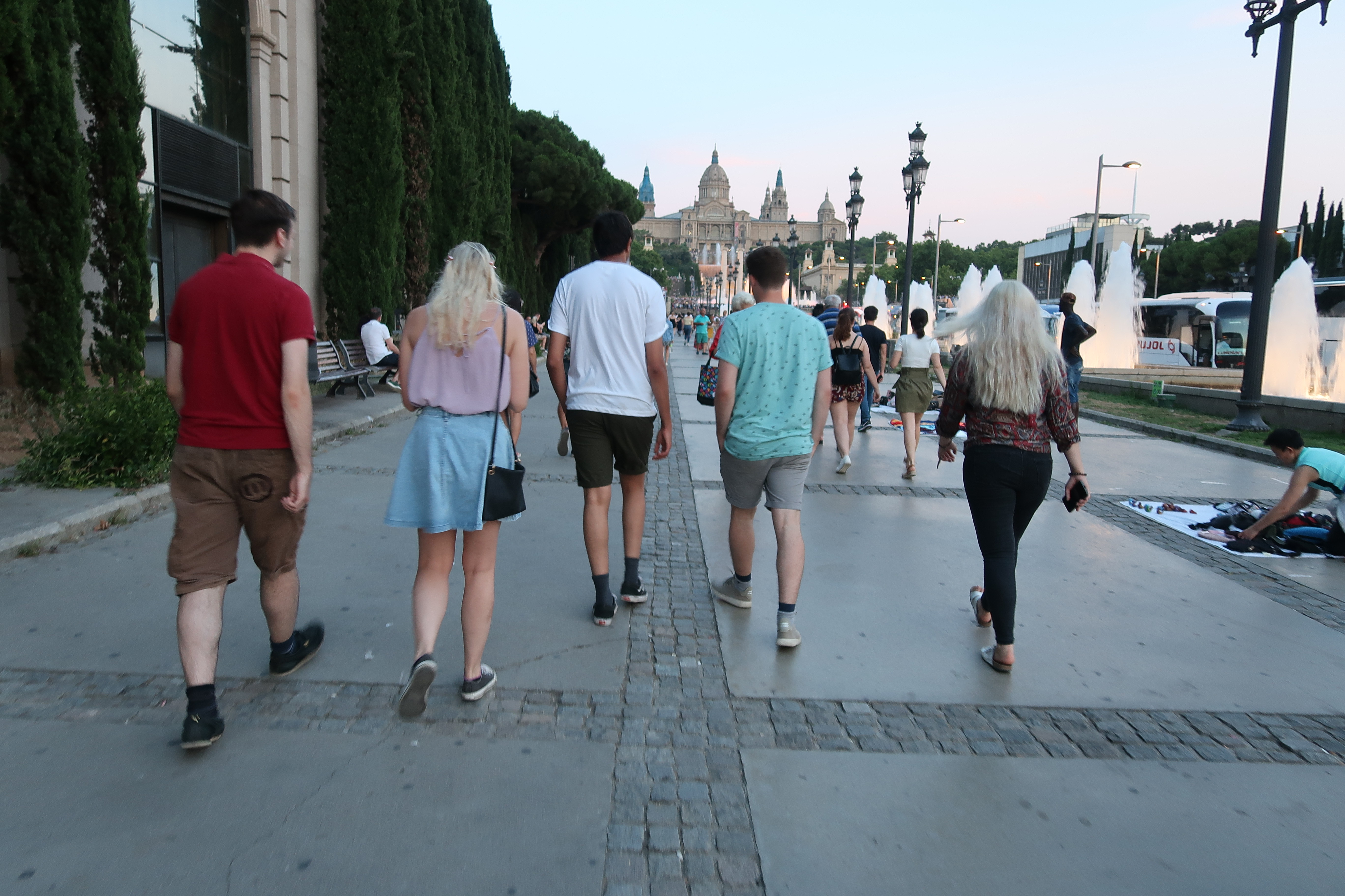 Friends walking towards Magic Fountain in Barcelona